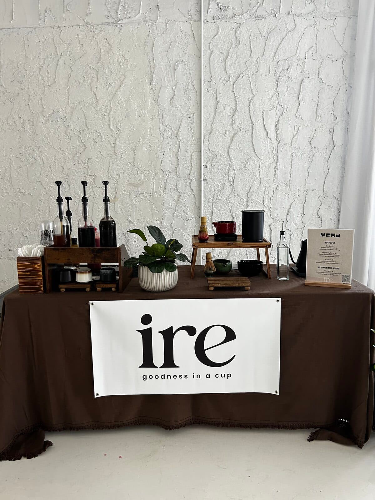 The ire bar dressed with linen and wood, set up before guests arrive