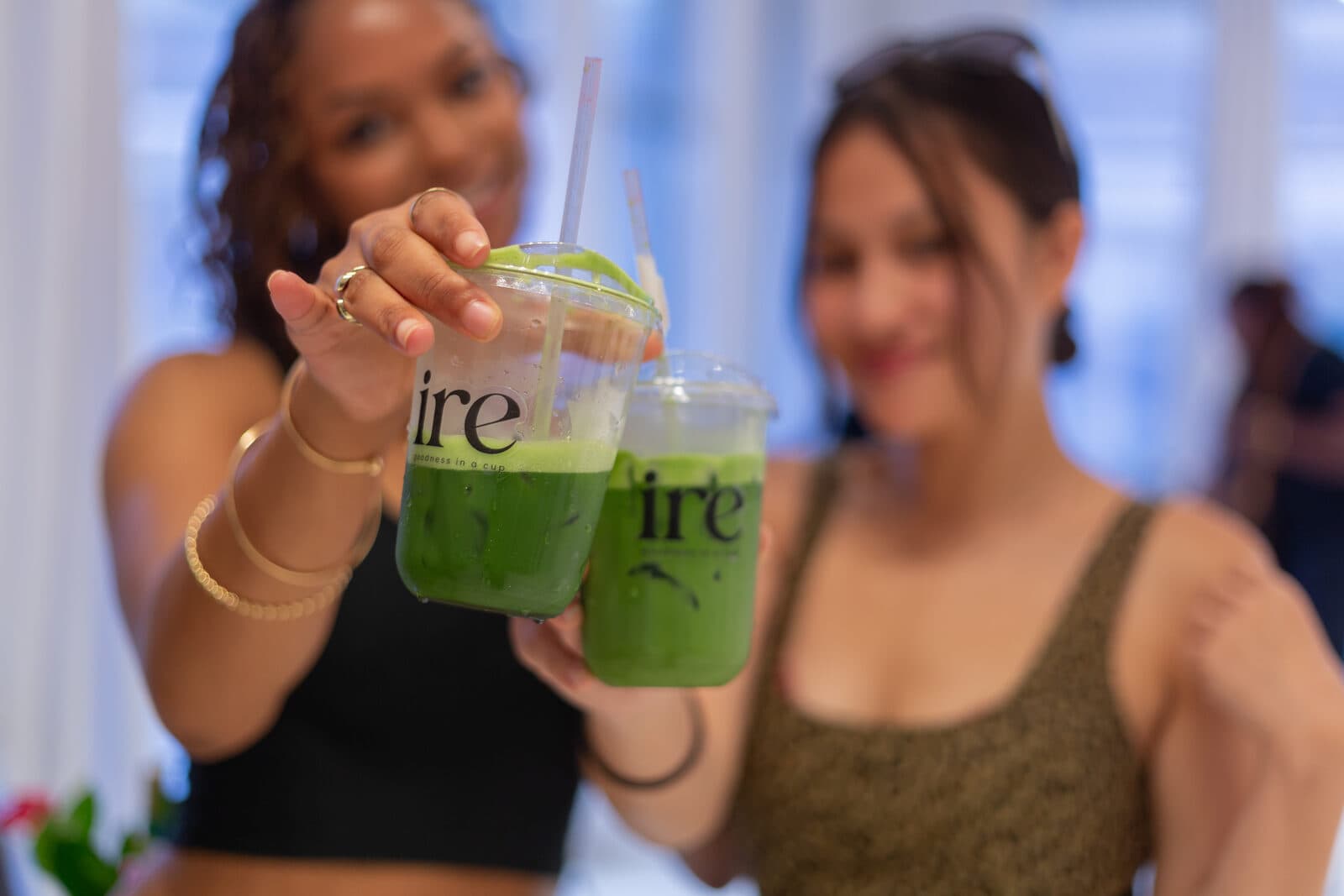 Two guests raising ire matcha cups at an event