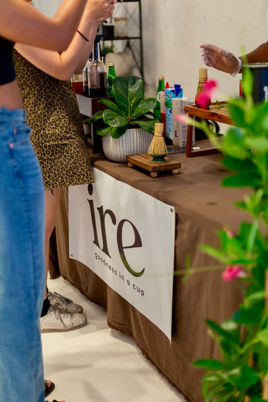 A drink being poured over ice behind the ire bar